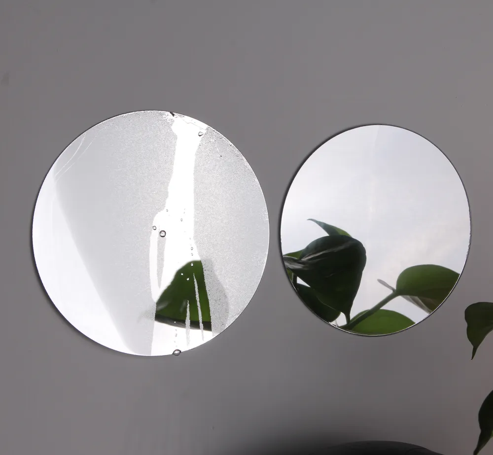 Two round acrylic mirrors showing anti-fog performance—one fogged, one clear